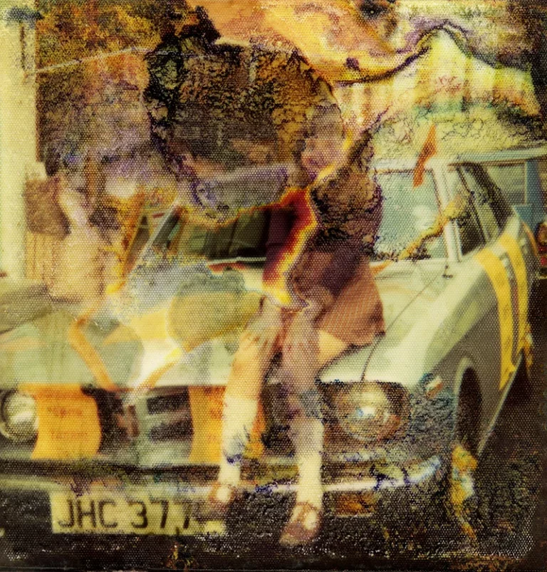 Mouldy photograph of a girl sitting on an old car found in an abandoned pub in Bexhill-on-Sea